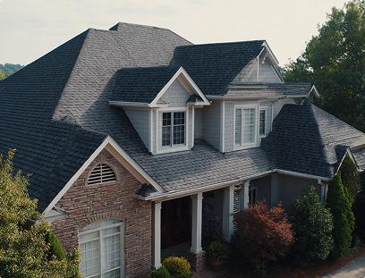 Aerial view of a two-story brick house with grey shingle roof and white trim windows